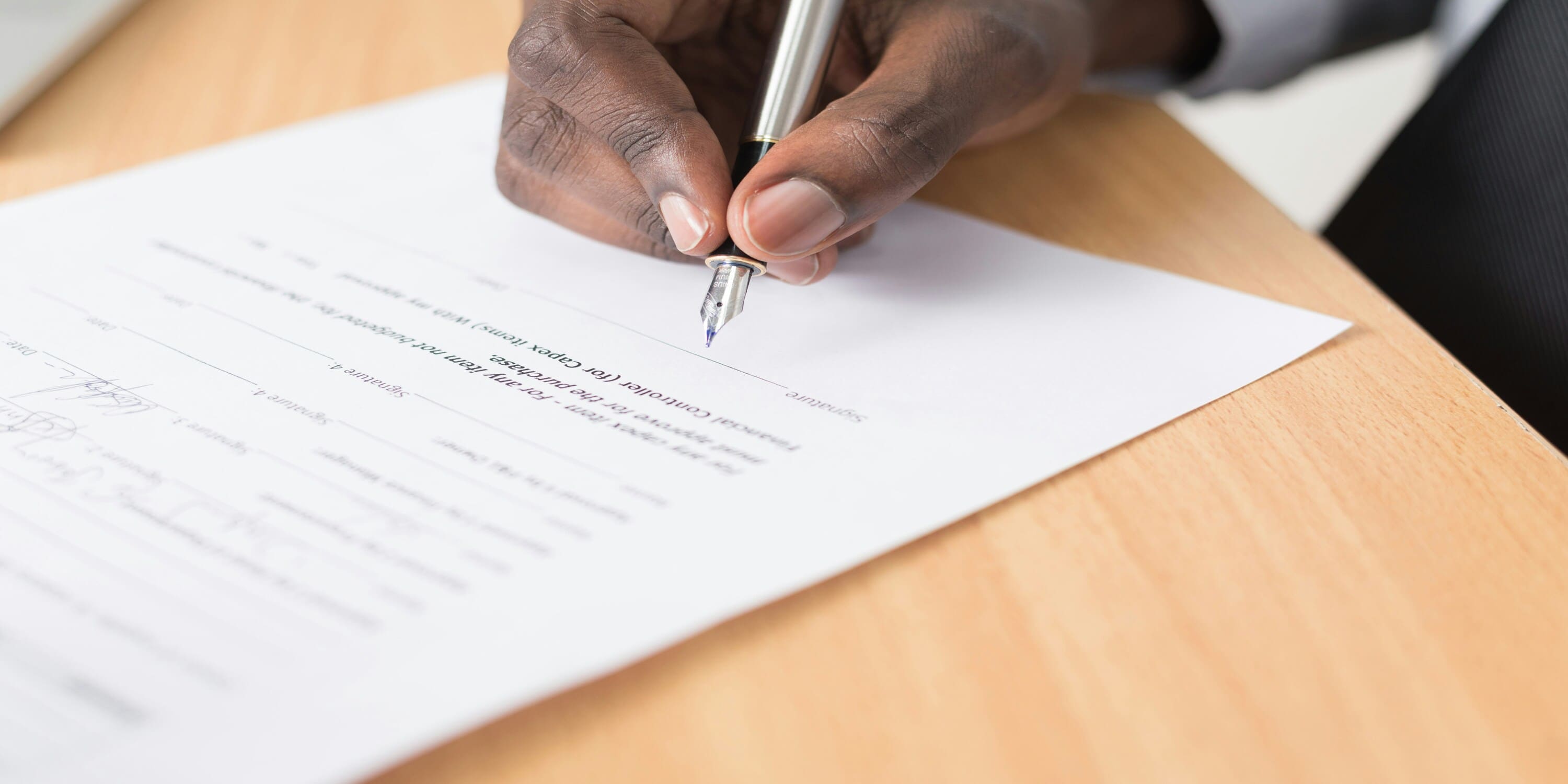 a man signing a Form F in Dubai
