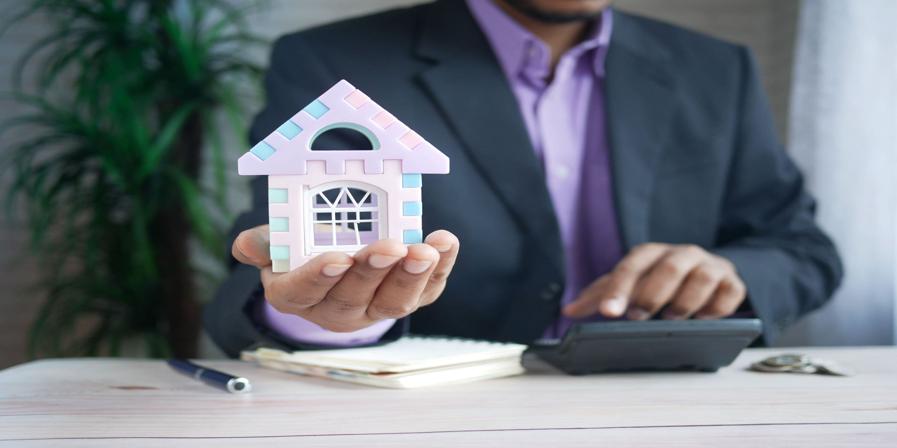 man calculating property transfer fees in Dubai
