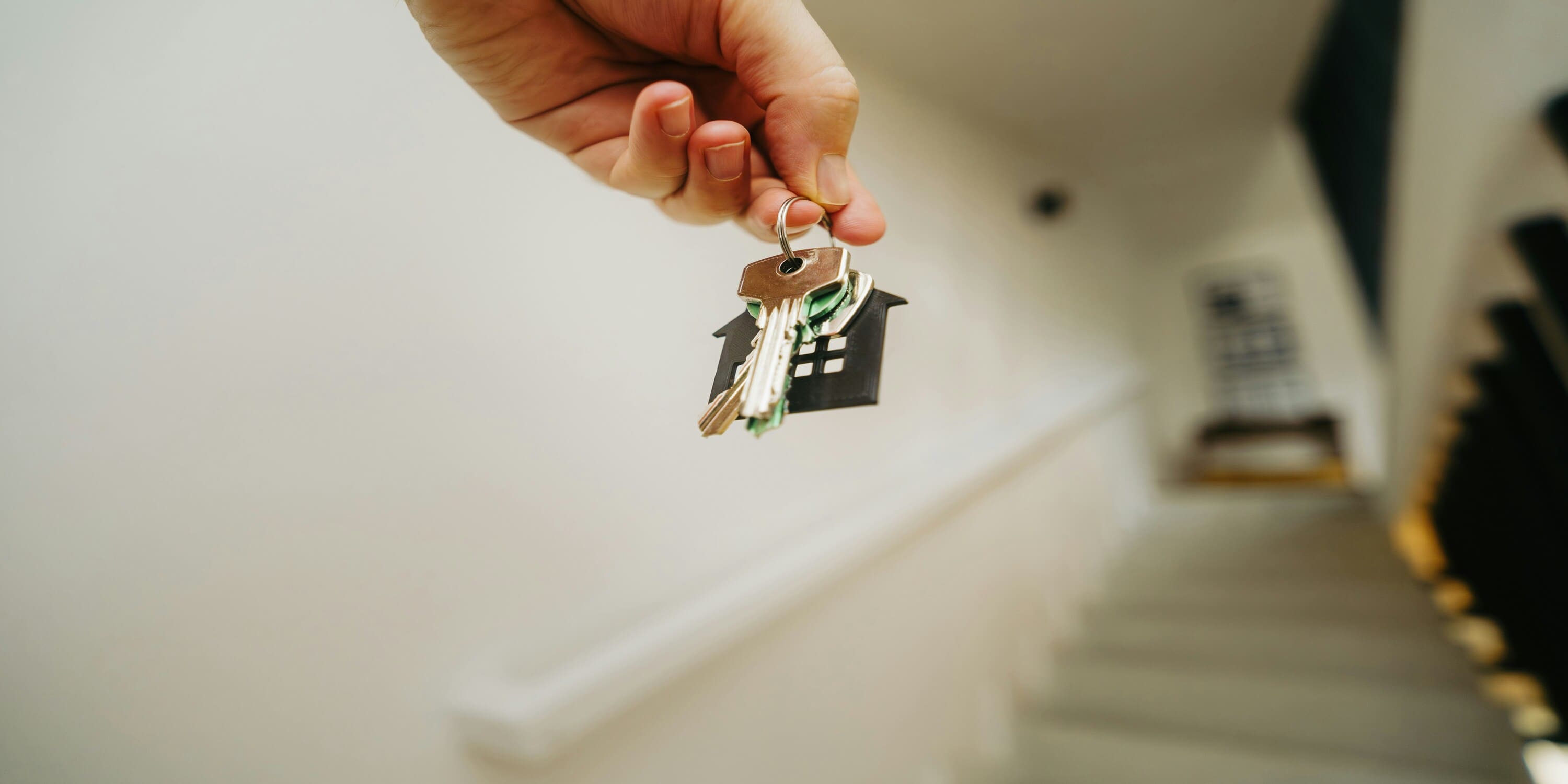 a person holding home keys